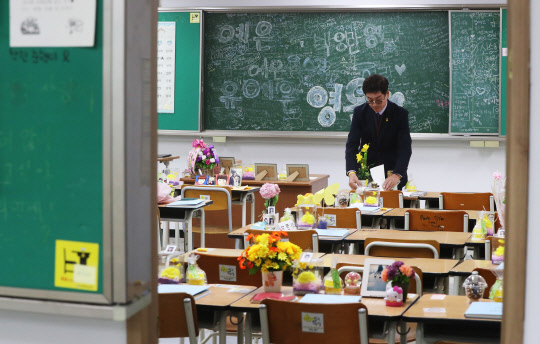 세월호 참사 당시 2학년 학생과 교사들이 사용하던 교실과 교무실을 임시 이전해 재현한 '단원고 416 기억교실'이 일반에 공개된 21일 경기도 안산시 안산교육지원청 별관에서 유가족이 교실을 살펴보고 있다.